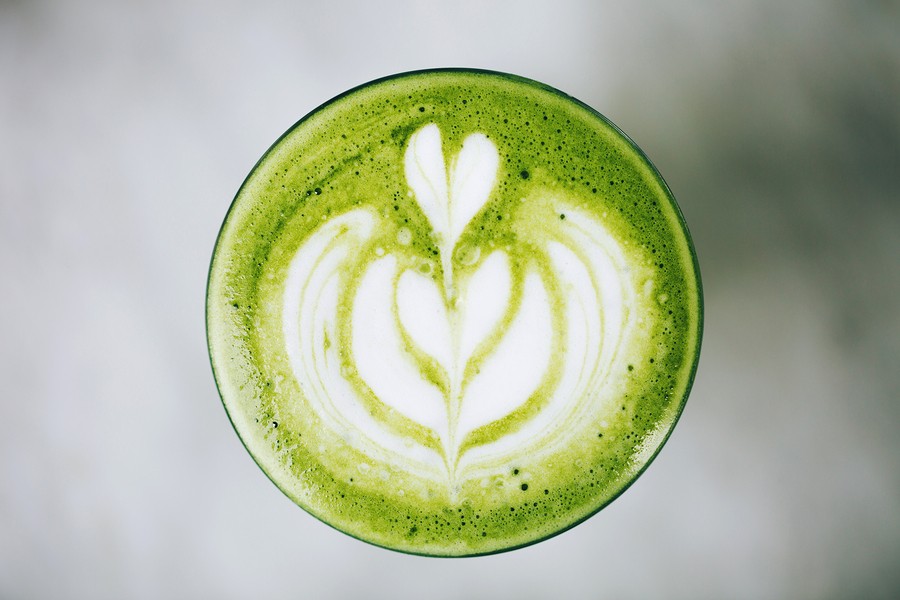 Trendy Green Latte, Macro. Avocado Or Matcha Foam With Latte Art.